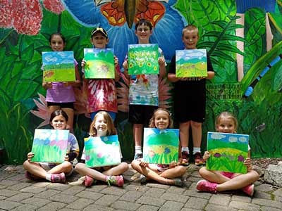 Kids holding up their nature art