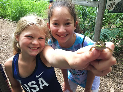 Girls holding frog