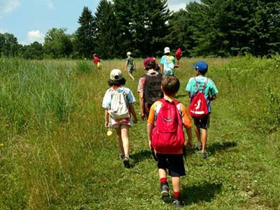 Kids taking hike through field